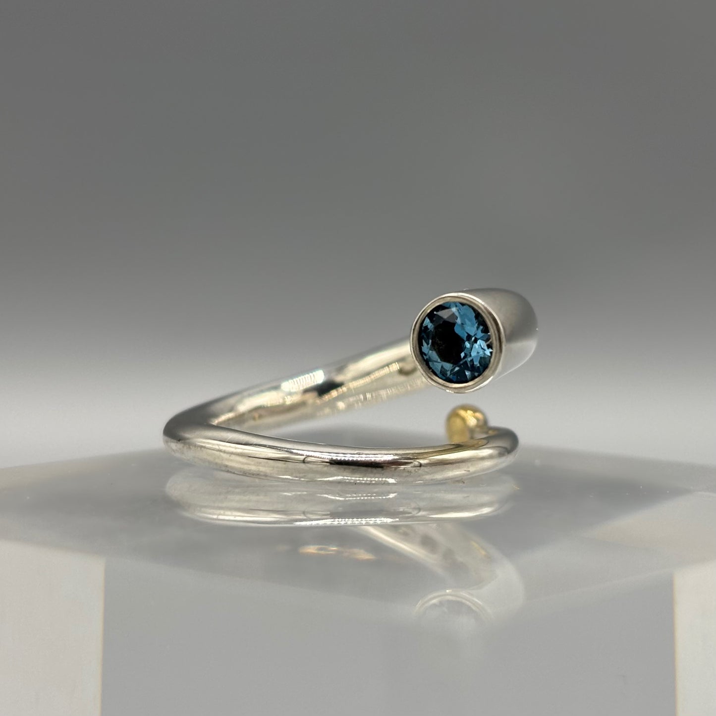 Paul Finch - Ring: Silver spiral with blue topaz & solid 18ct Yellow Gold bead