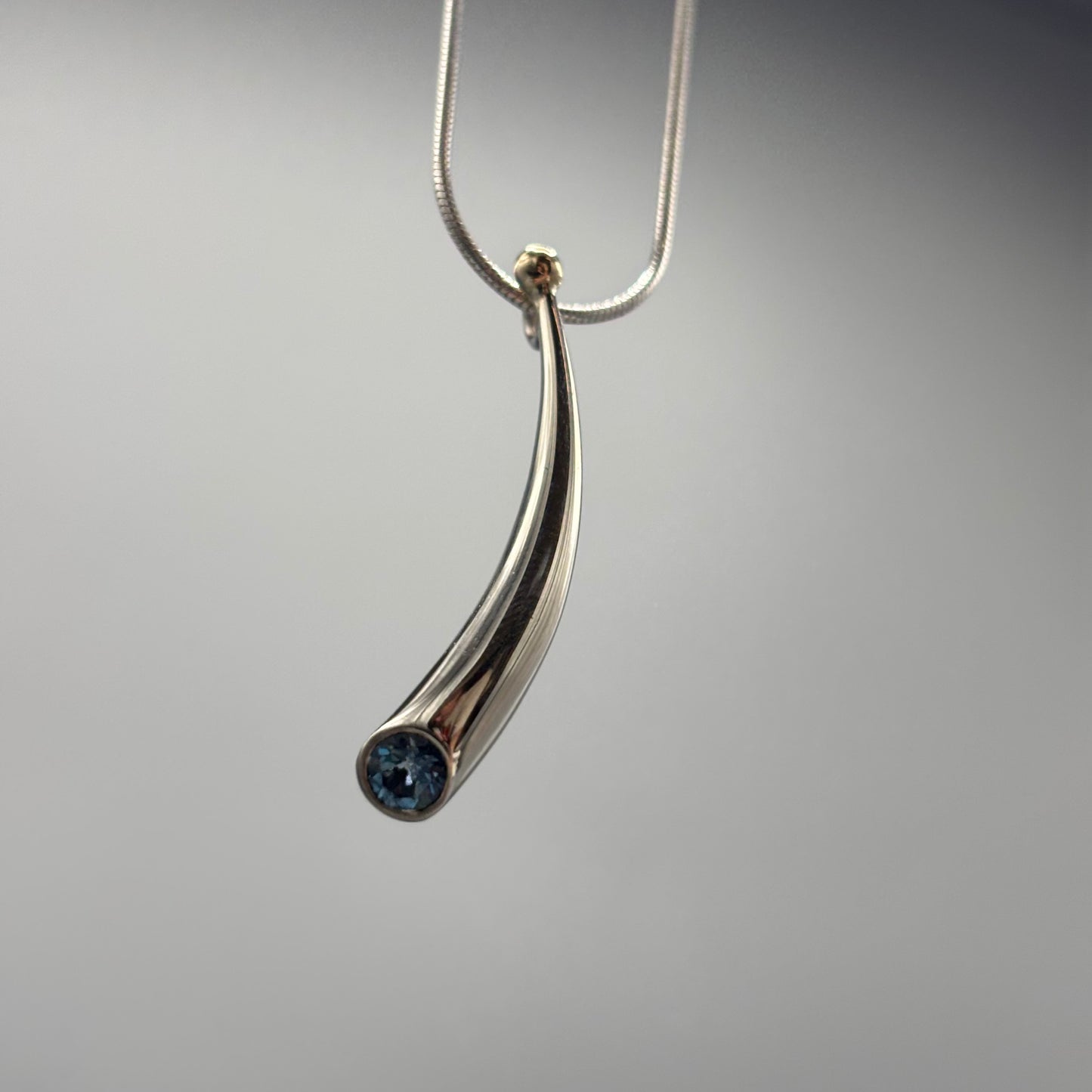 Paul Finch - Pendant: Short curved solid silver/blue topaz/solid 18ct Yellow Gold Bead